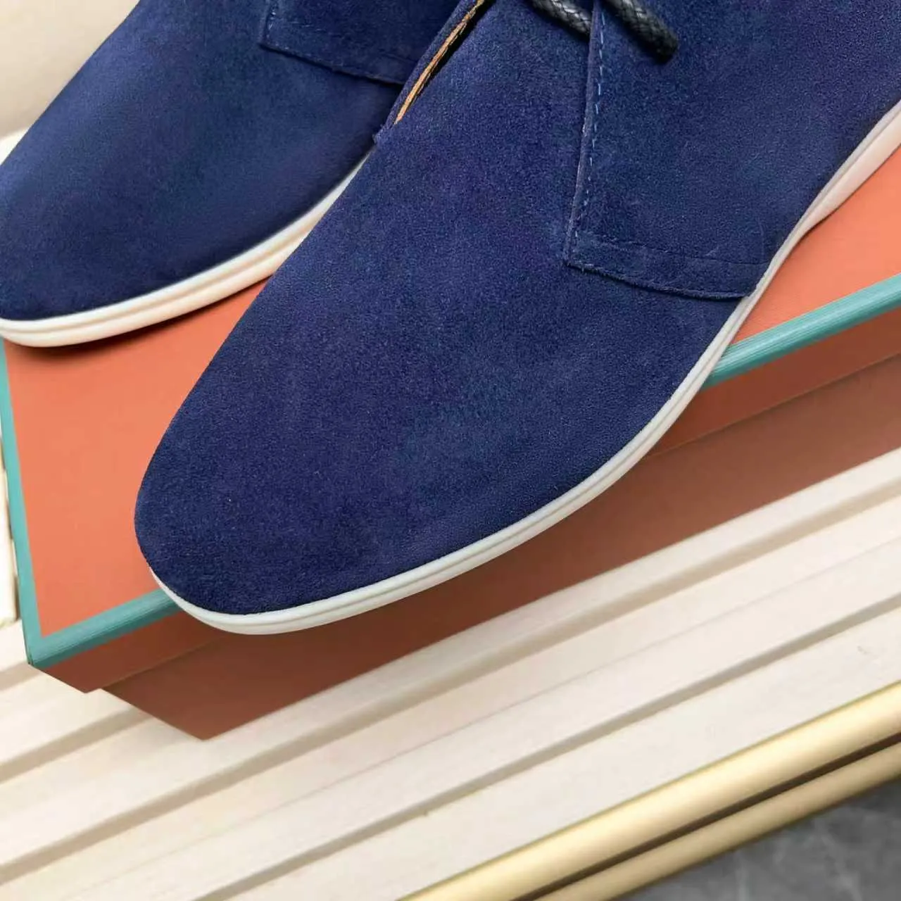 Men's Shoes 💰420 Loro Piana reimagines the desert boot—a modern, comfortable interpretation of a classic 1940s style. Crafted from suede calfskin, it exudes elegance. The tight texture of suede calfskin is not only durable but also looks casual and sophisticated. Add a timeless piece to your shoe collection, harmoniously blending comfort, style and Loro Piana's heritage of craftsmanship. Acetate satin detail on the inside White sole with LP lettering for added traction Space for a personalized signature on the heel Tonal suede trim Upper: 100% cow split suede Sole: 100% Rubber lining: Cow leather